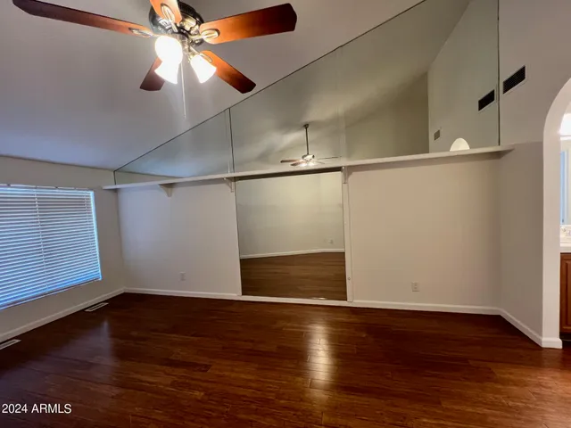 a view of empty room with wooden floor