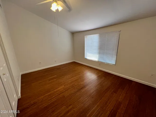 a view of a room with wooden floor closet and chandelier