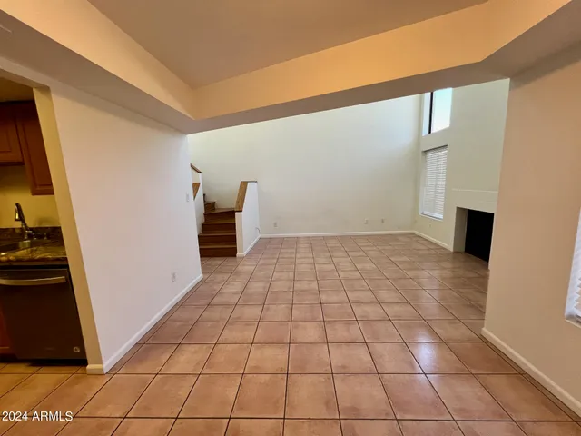 a kitchen with granite countertop wooden cabinets stainless steel appliances and a window