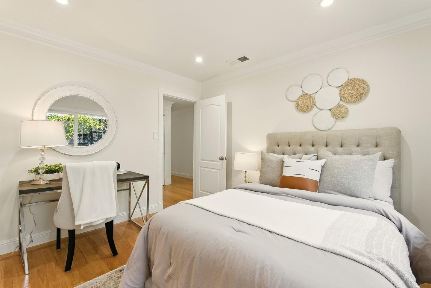 1807 Hunt Drive Burlingame, CA 94010 - Photo 25 of 46 a bedroom with a bed and a chandelier