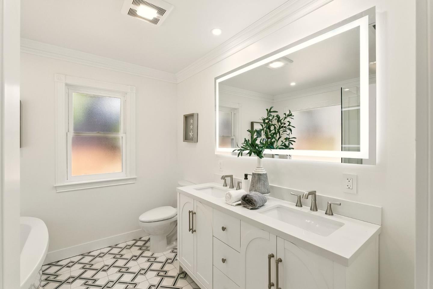 1807 Hunt Drive Burlingame, CA 94010 - Photo 31 of 46 a bathroom with a toilet a sink a mirror a window and vanity