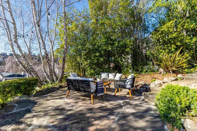 a view of backyard with sitting area