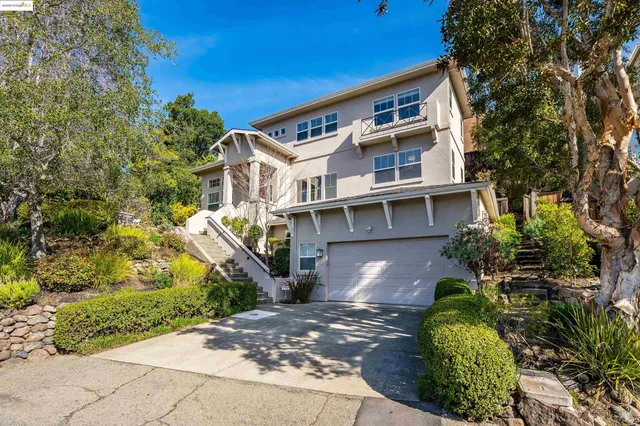 a front view of a house with a garden