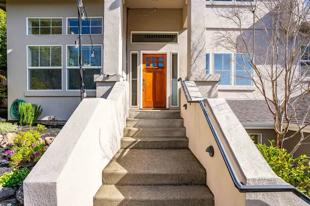 a view of a large building with large windows and plants