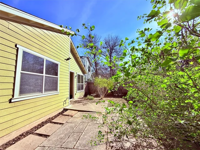 a house with a tree in the back yard