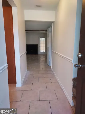 a view of hallway with a sink and a fireplace