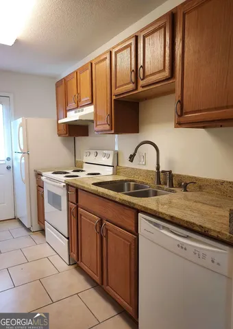 a kitchen with stainless steel appliances granite countertop a sink stove and cabinets