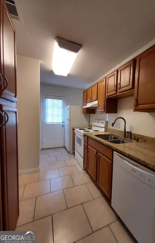 a kitchen with stainless steel appliances granite countertop a sink stove and cabinets