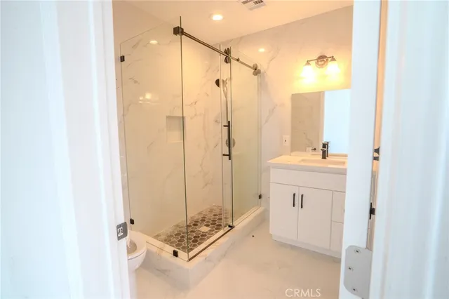 a view of a hall with a dining table and chairs
