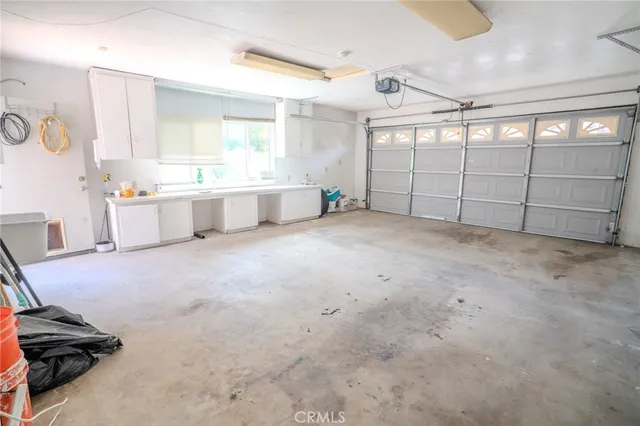 a view of a house with a yard and potted plants