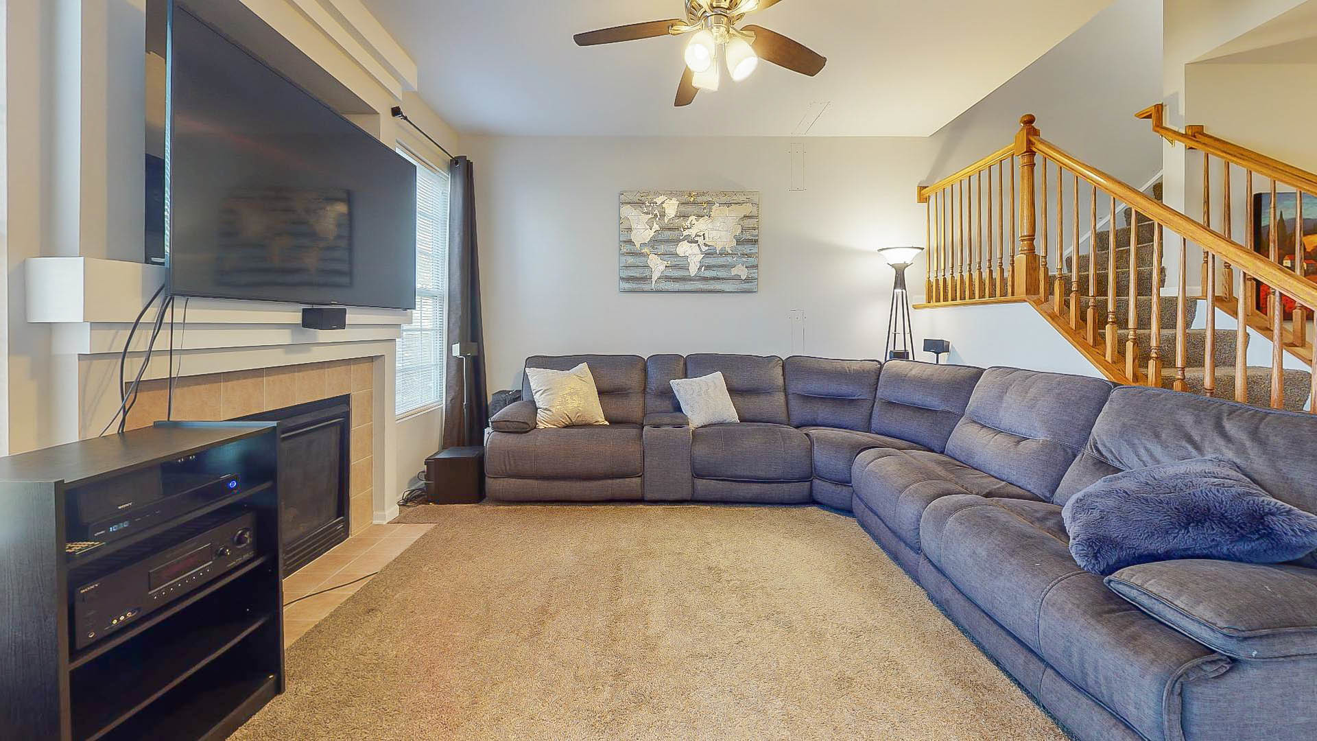 1916 West Cobblestone Road Romeoville, IL 60446 - Photo 2 of 21 a living room with furniture a flat screen tv and a fireplace