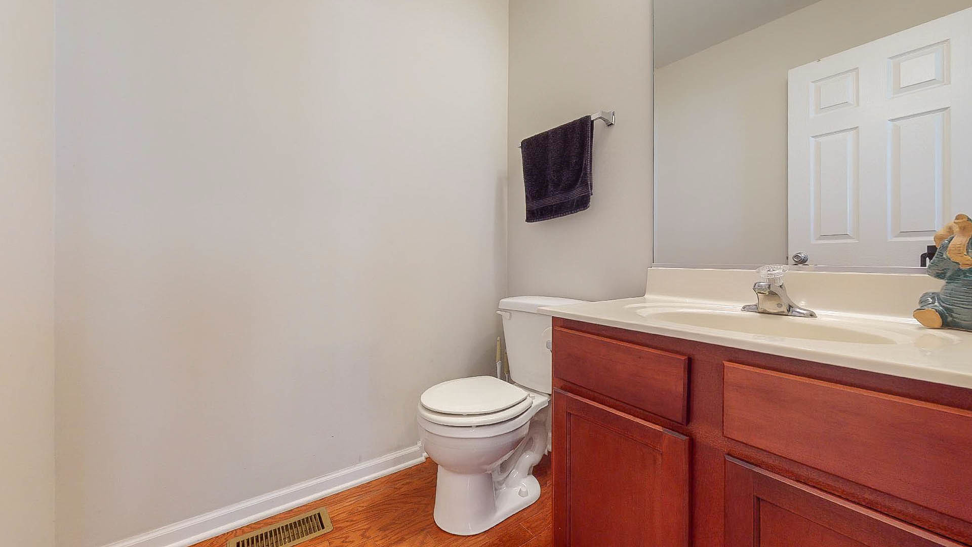 1916 West Cobblestone Road Romeoville, IL 60446 - Photo 19 of 21 a bathroom with a toilet a sink and mirror