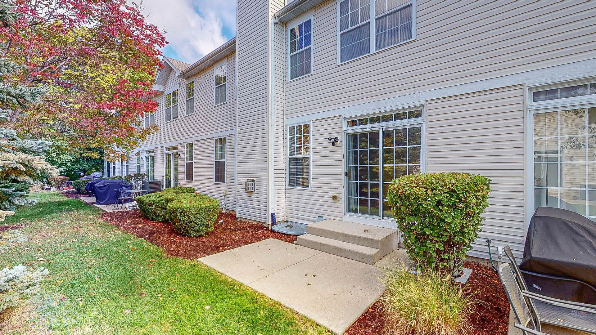 1916 West Cobblestone Road Romeoville, IL 60446 - Photo 21 of 21 a view of a house with backyard sitting area and garden