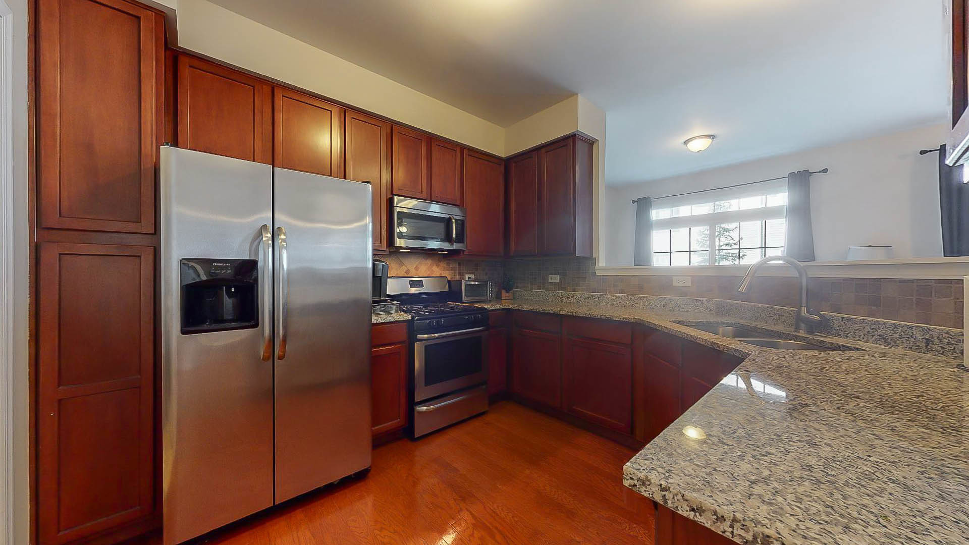 1916 West Cobblestone Road Romeoville, IL 60446 - Photo 6 of 21 a kitchen with stainless steel appliances granite countertop a refrigerator a stove and a sink