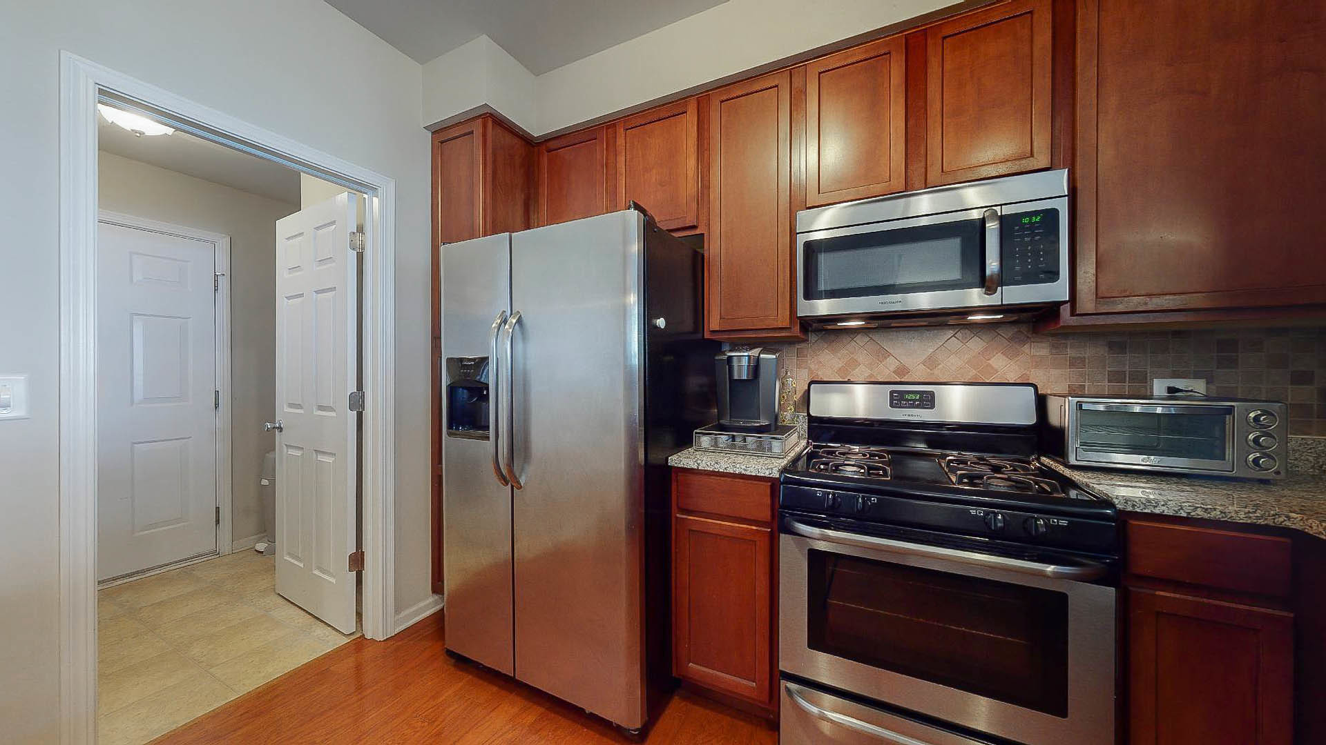 1916 West Cobblestone Road Romeoville, IL 60446 - Photo 7 of 21 a kitchen with stainless steel appliances granite countertop a refrigerator stove and microwave