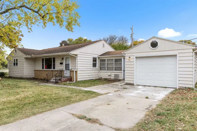 a view of a house with a yard and garage