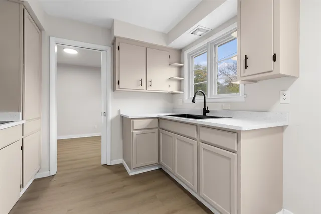 a kitchen with cabinets and window