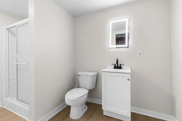 a white toilet sitting next to a bathroom sink