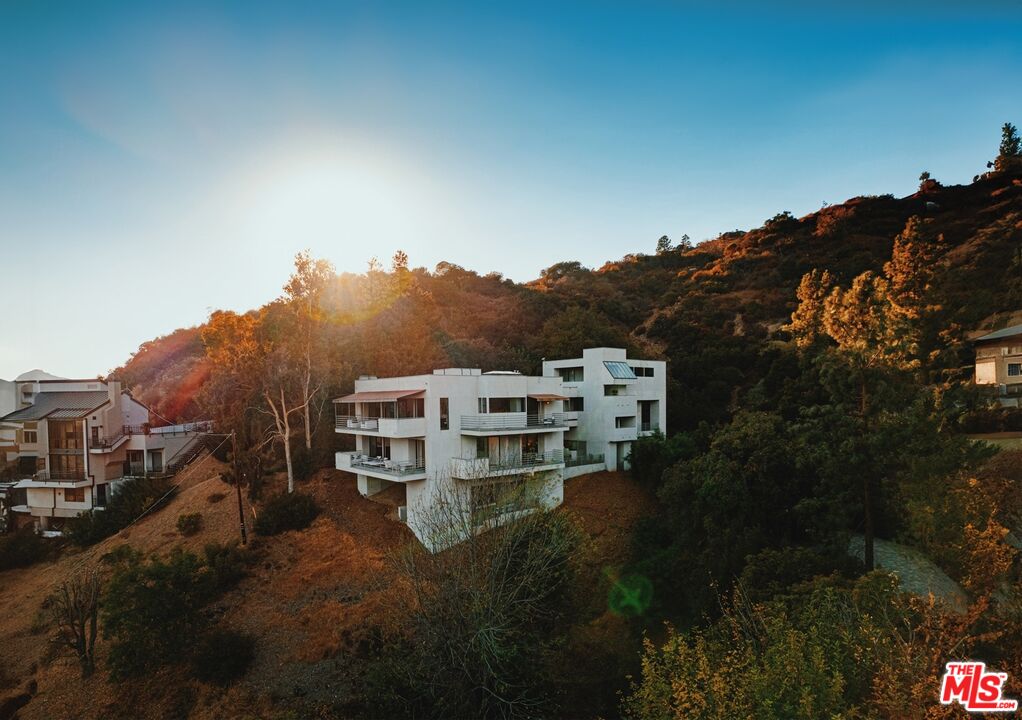 a view of a house with a mountain in front of it