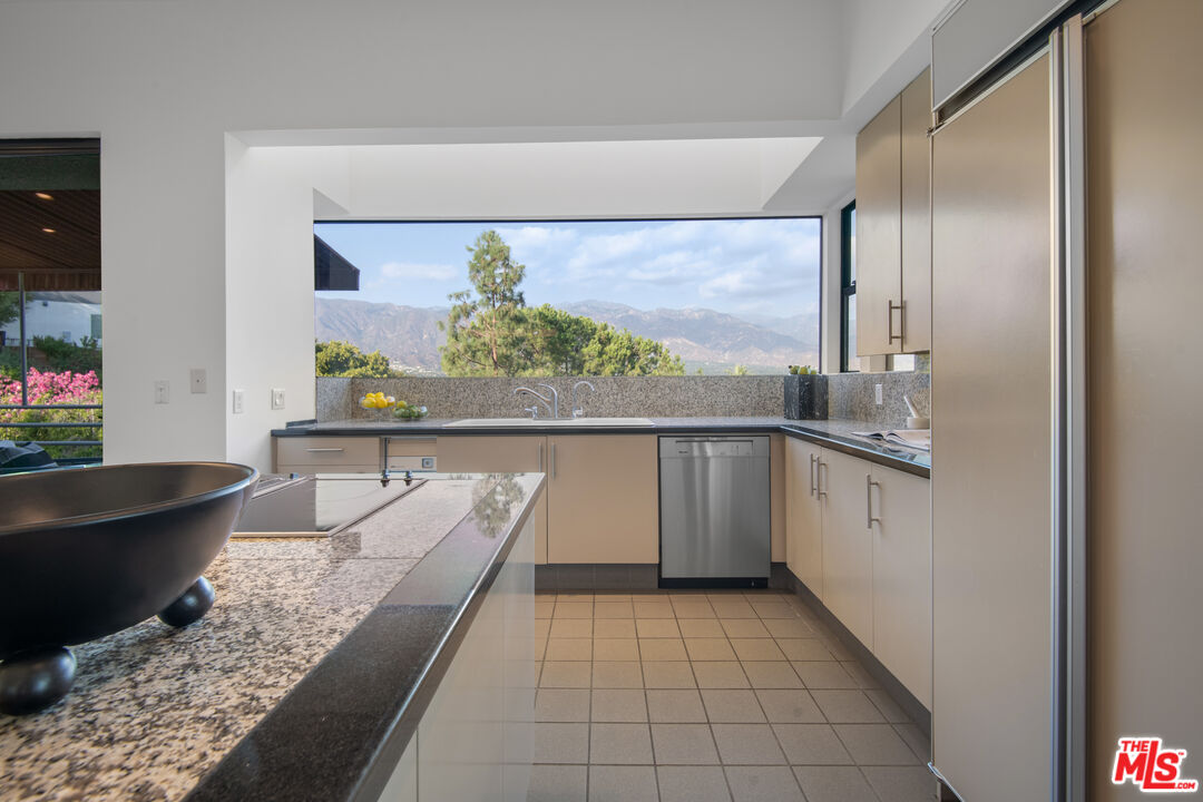 1500 Inverness Drive Pasadena, CA 91103 - Photo 25 of 66 a kitchen with stainless steel appliances granite countertop a sink and a counter top space
