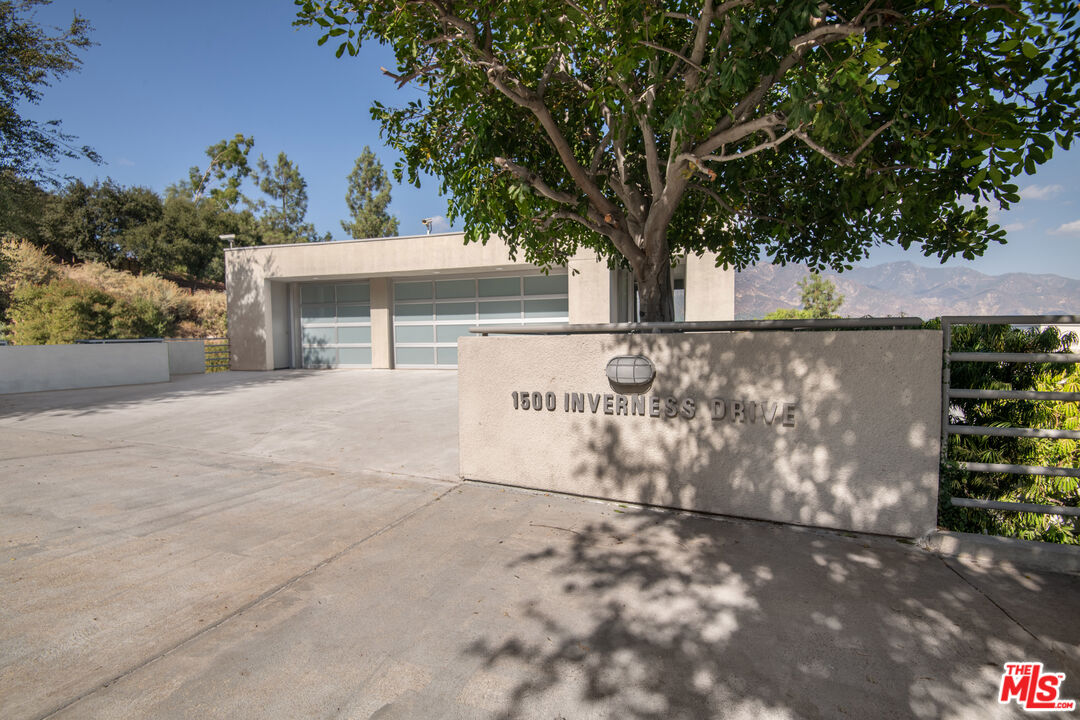 1500 Inverness Drive Pasadena, CA 91103 - Photo 4 of 66 a view of a outdoor space with signage and trees