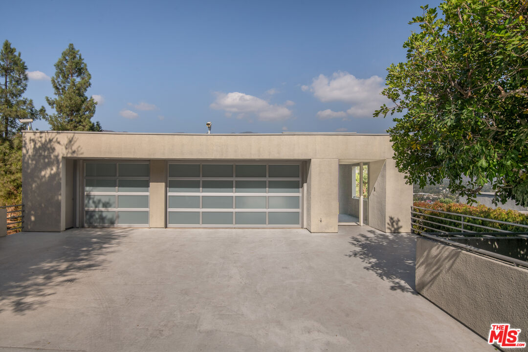 1500 Inverness Drive Pasadena, CA 91103 - Photo 5 of 66 a front view of a house with a yard and garage