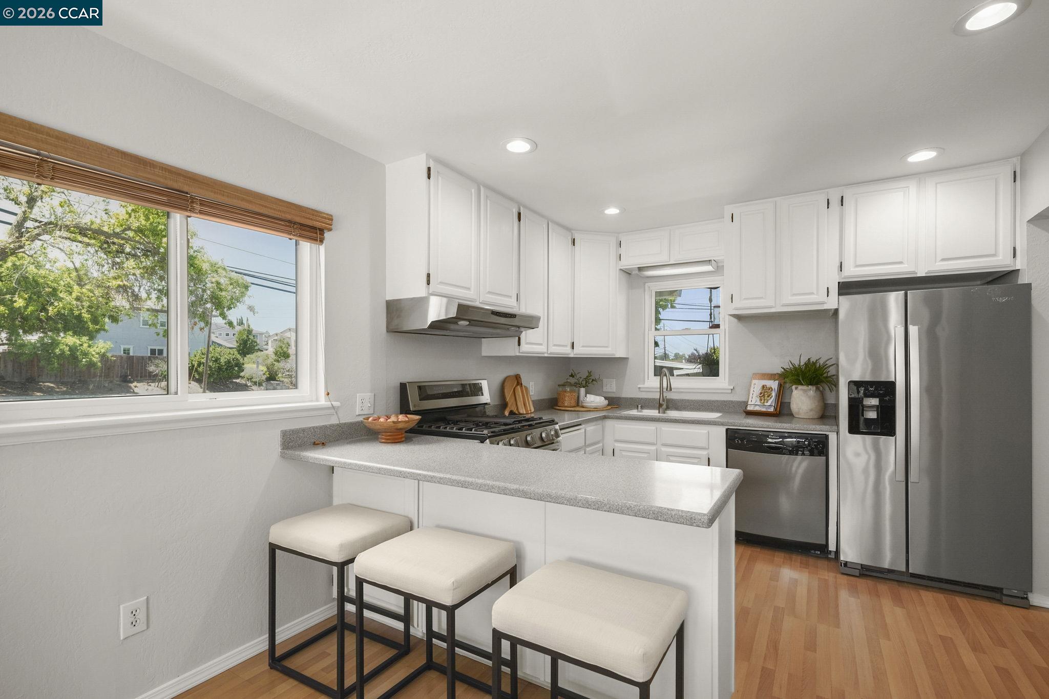 4311 Cowell Road Concord, CA 94521 - Photo 12 of 29 a kitchen with stainless steel appliances granite countertop a stove a sink a refrigerator white cabinets and a refrigerator