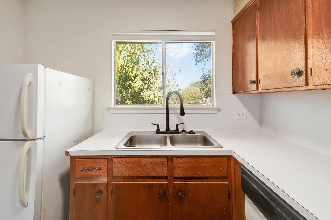 509 Cedar Drive, Unit 207 Georgetown, TX 78628 - Photo 11 of 19 a kitchen with a sink and a window