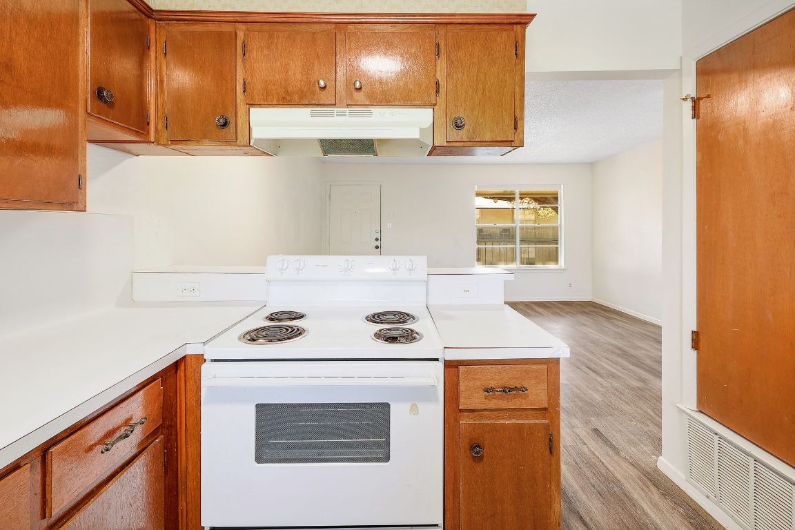 509 Cedar Drive, Unit 207 Georgetown, TX 78628 - Photo 12 of 19 a kitchen with stainless steel appliances granite countertop a sink stove and cabinets