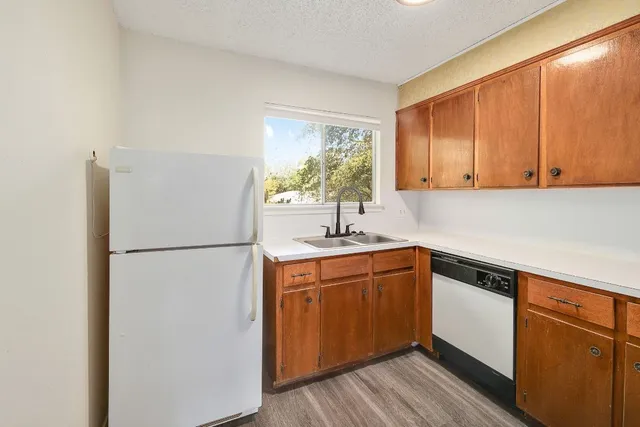a kitchen with stainless steel appliances granite countertop a refrigerator sink and cabinets