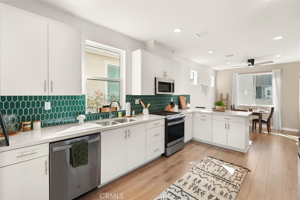 540 Sparrowhawk Way Rancho Mission Viejo, CA 92694 - Photo 13 of 54 a kitchen with a sink stove and cabinets