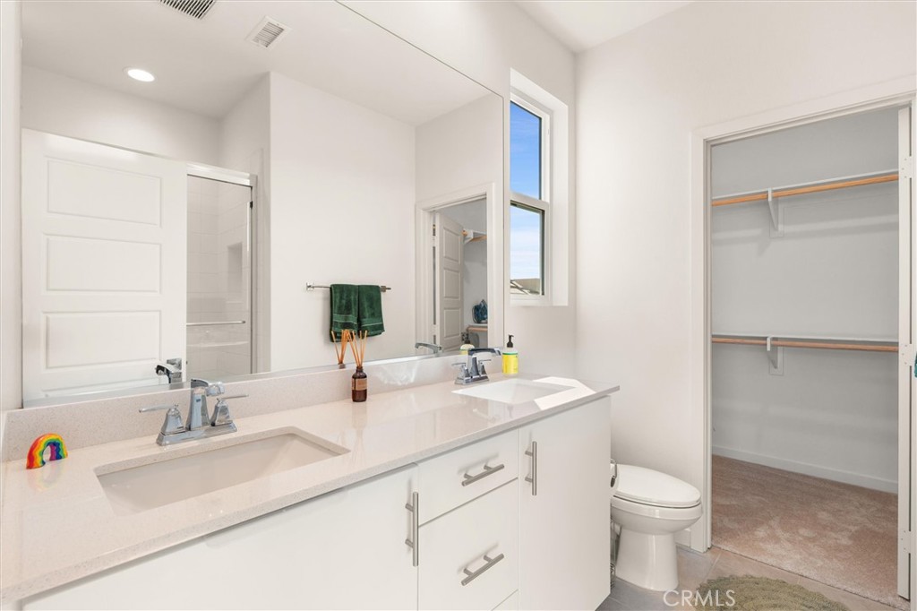540 Sparrowhawk Way Rancho Mission Viejo, CA 92694 - Photo 20 of 54 a bathroom with a double vanity sink toilet and a mirror
