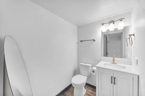 a bathroom with a sink toilet and mirror
