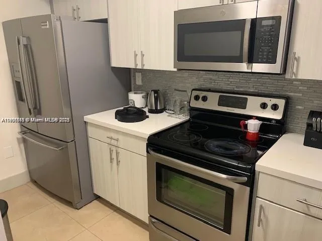 a kitchen with a stove microwave and sink