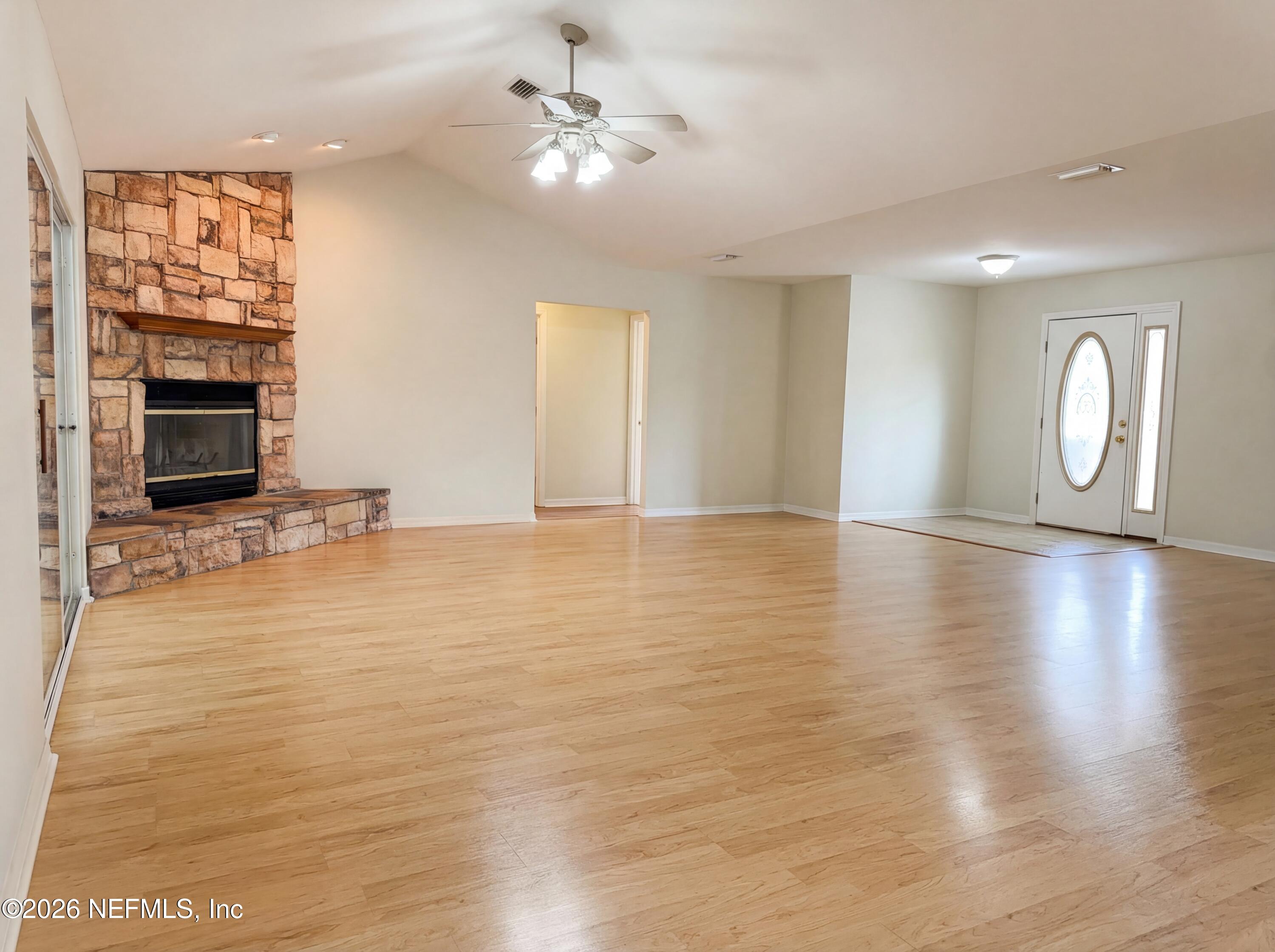 7628 Alameda Way Keystone Heights, FL 32656 - Photo 12 of 29 a view of an empty room with window and wooden floor