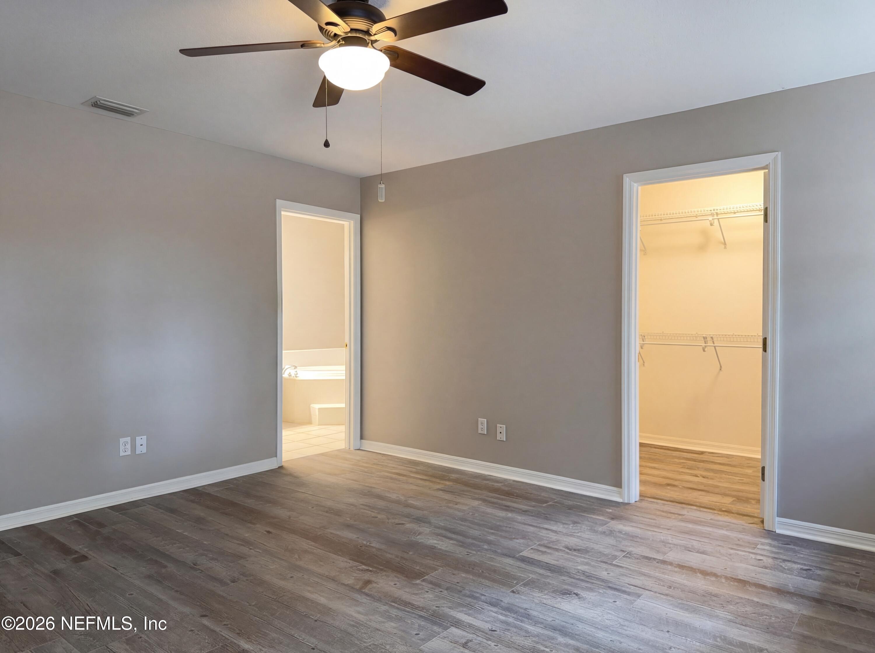 7628 Alameda Way Keystone Heights, FL 32656 - Photo 17 of 29 an empty room with wooden floor closet and windows