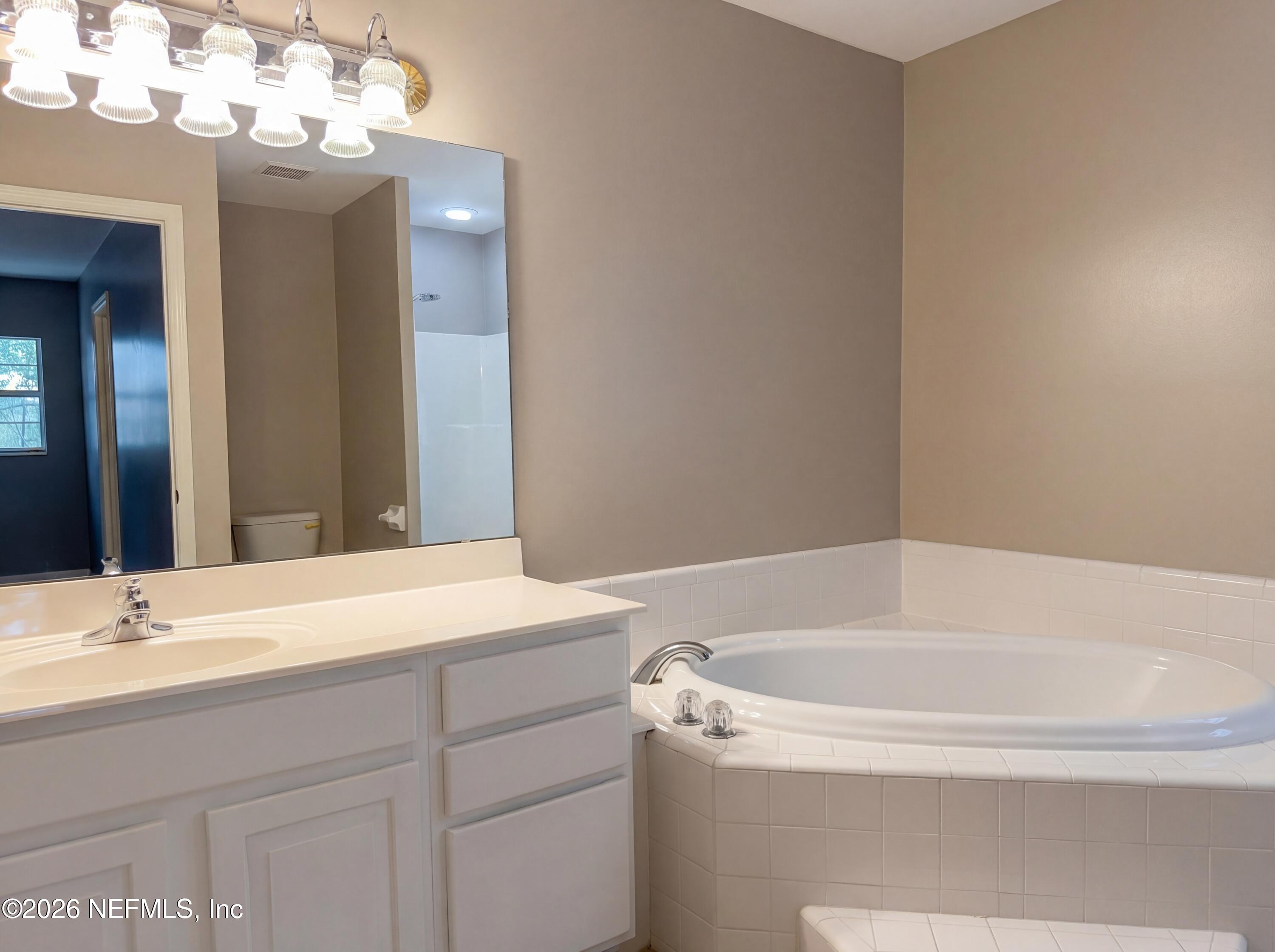 7628 Alameda Way Keystone Heights, FL 32656 - Photo 19 of 29 a bathroom with a bathtub and a sink