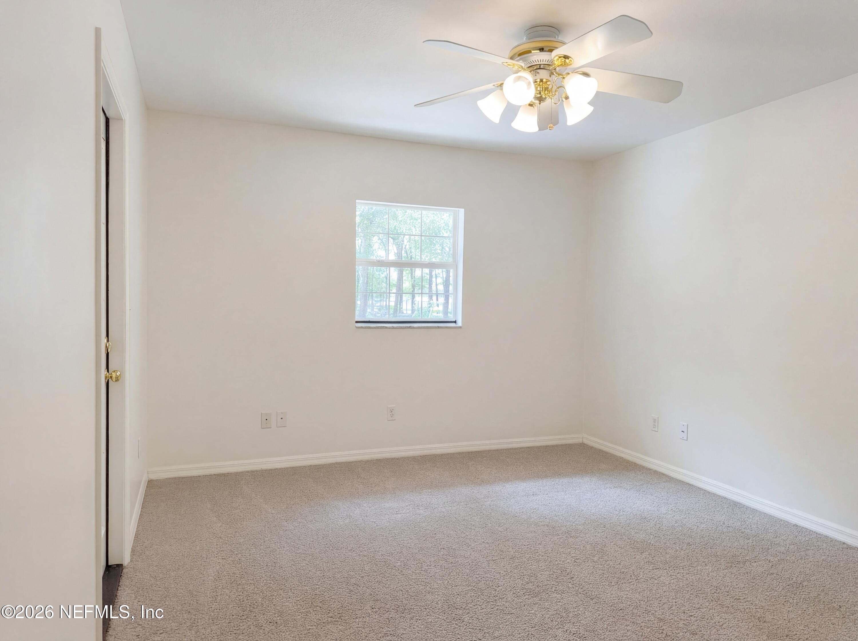 7628 Alameda Way Keystone Heights, FL 32656 - Photo 27 of 29 an empty room with a window and a fan