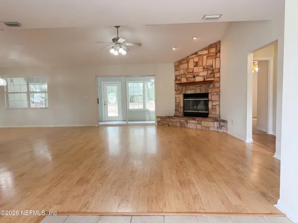 wooden floor in an empty room with a fireplace