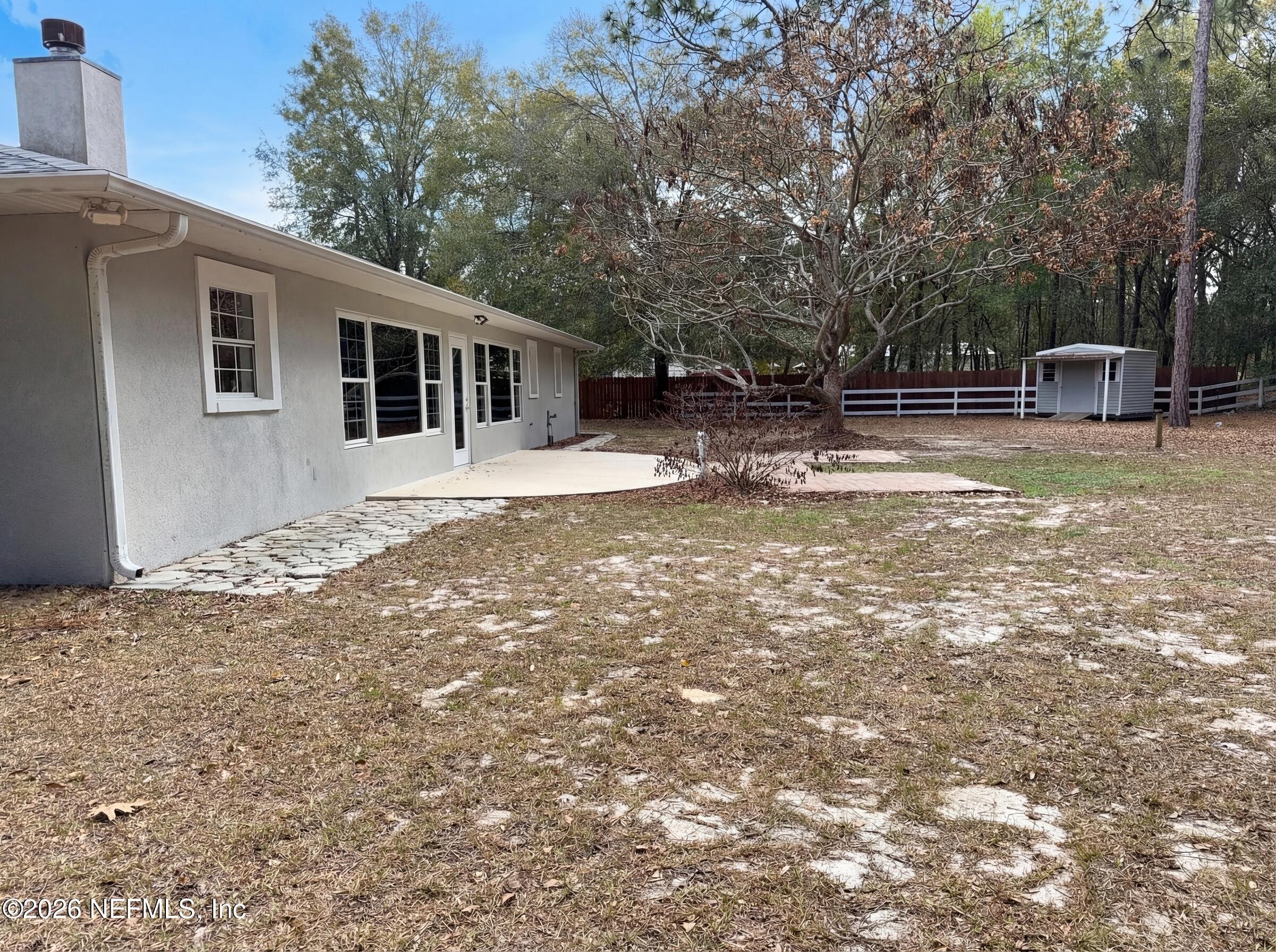 7628 Alameda Way Keystone Heights, FL 32656 - Photo 5 of 29 a view of a house with backyard and trees