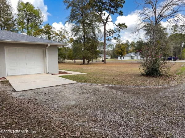 a view of a yard with a tree