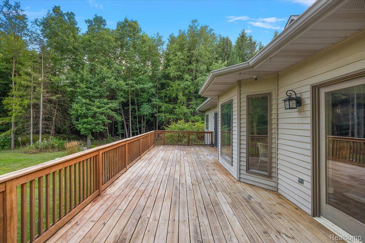 707 West Sutton Road Metamora, MI 48455 - Photo 75 of 84 Expansive wood deck with a natural finish, featuring a wood railing