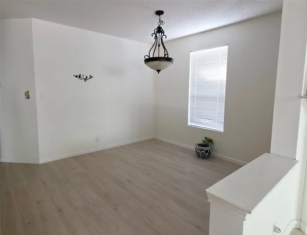 a view of a room with wooden floor and windows