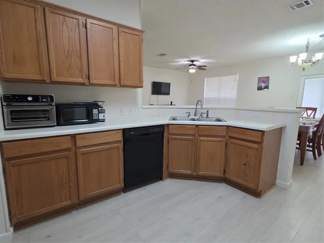 a kitchen with a sink and cabinets
