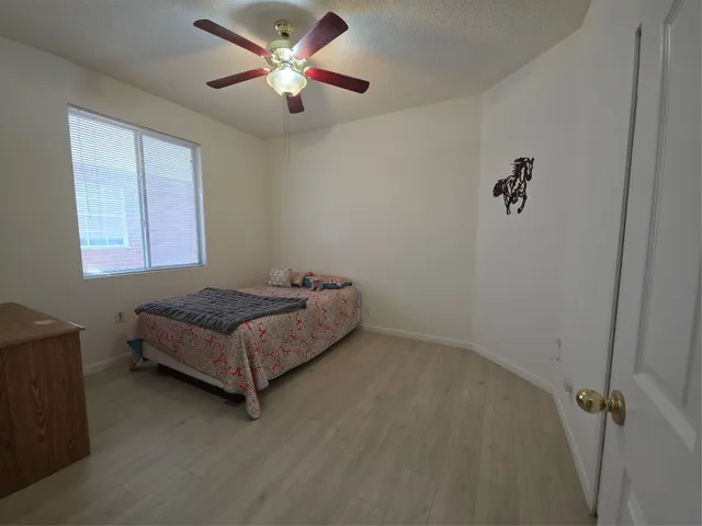 a bedroom with a bed and window