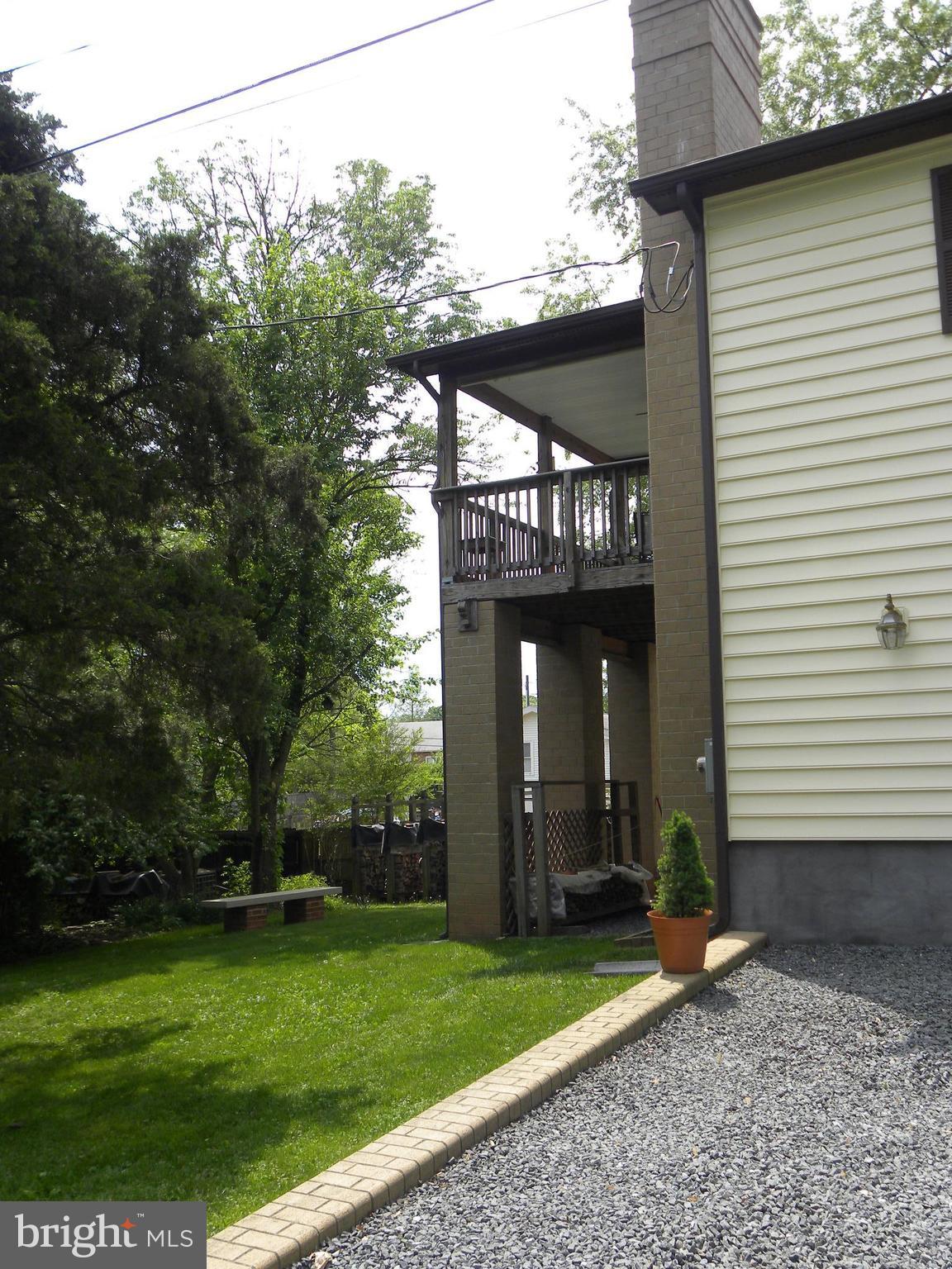 7415 Bull Run Road Manassas, VA 20111 - Photo 2 of 30 a view of a house with brick walls and a yard with plants