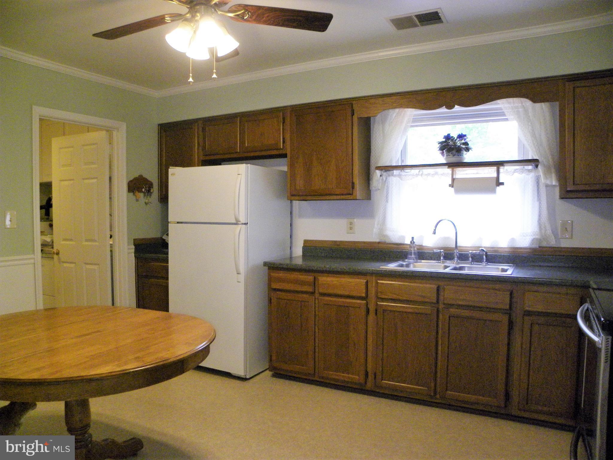 7415 Bull Run Road Manassas, VA 20111 - Photo 21 of 30 a kitchen with stainless steel appliances granite countertop a refrigerator and a sink