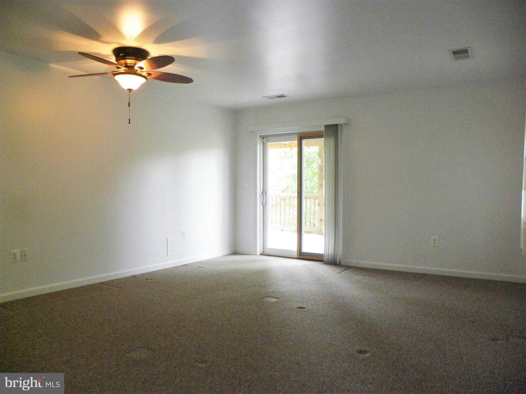 7415 Bull Run Road Manassas, VA 20111 - Photo 23 of 30 an empty room with a ceiling fan and a window