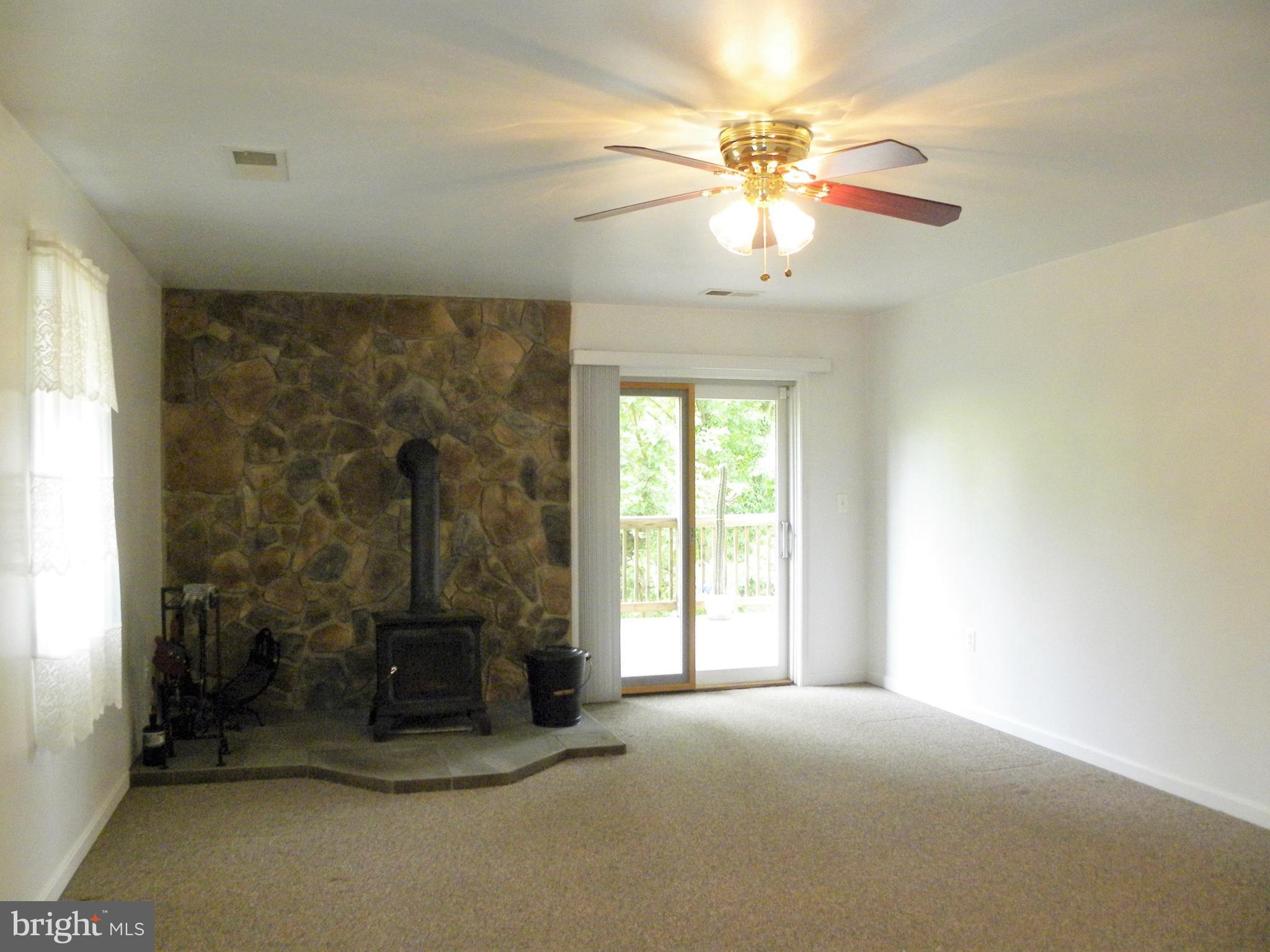 7415 Bull Run Road Manassas, VA 20111 - Photo 28 of 30 an empty room with a chandelier fan and windows