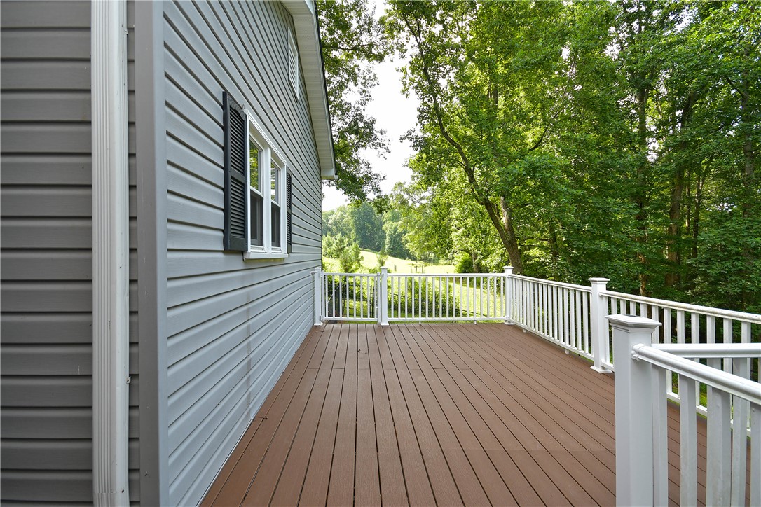197 Deer Creek Road Easley, SC 29640 - Photo 45 of 50 A spacious outdoor deck with wood planks provides serene views of the surrounding natural landscape.